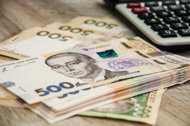 Ukrainian hryvnia, calculator and coins. Money background. Business concept.