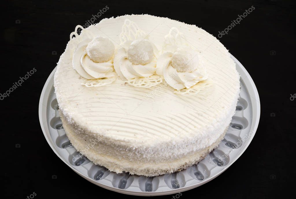 tasty, white cake with cream on a black background. View from above.