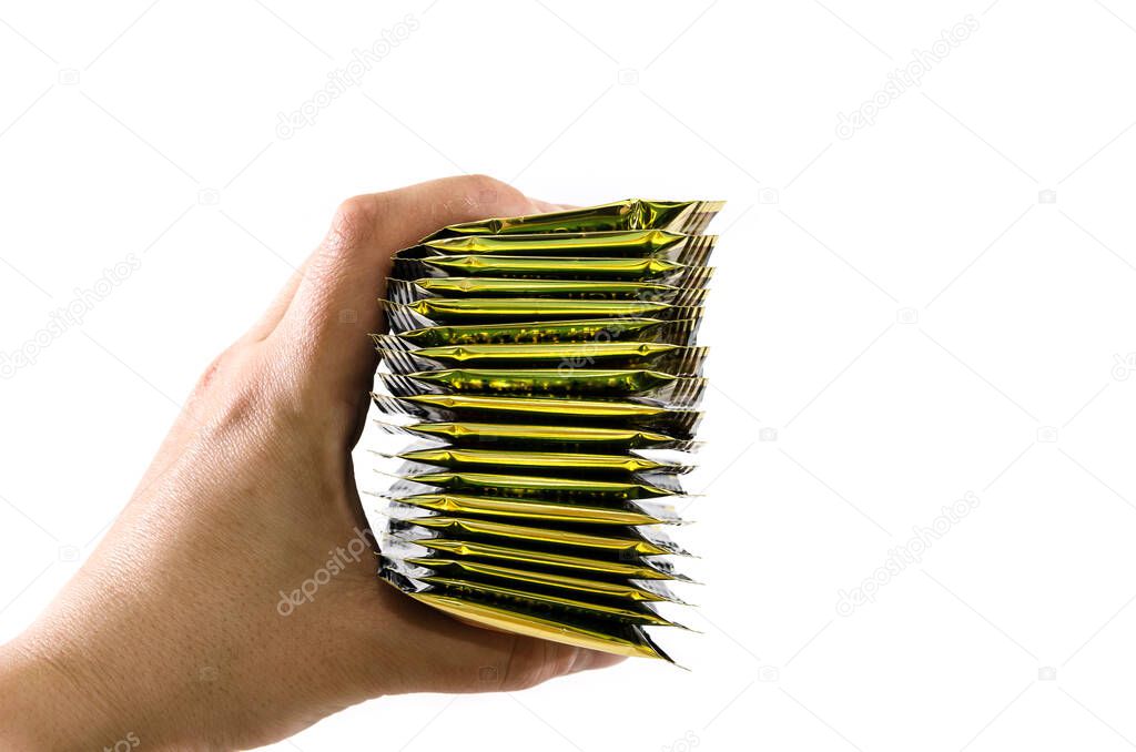 tea bags in hand on a white background. Copy space.