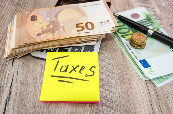Inscription Taxes Sticker Pen Calculator Euro Banknotes Business Concept — Stock Photo, Image