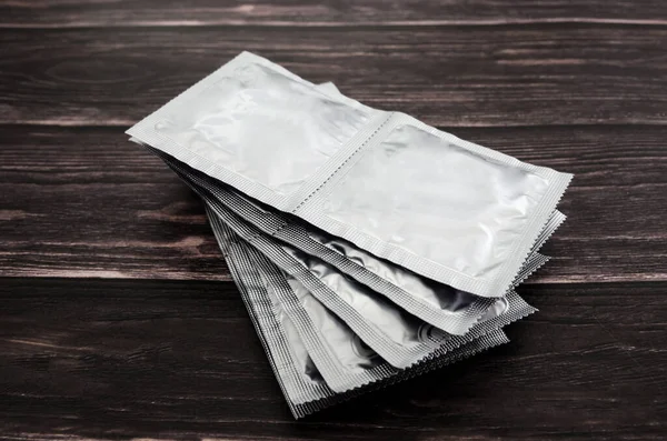 Many Condoms Wooden Background — Stock Photo, Image