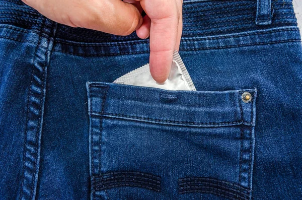 Hand Takes Out Condom Jeans Pocket Close — Stock Photo, Image