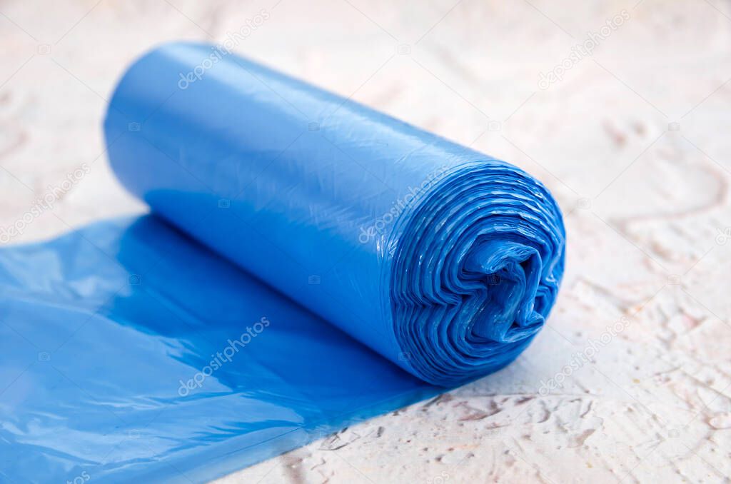 Blue roll of trash bags on the table.