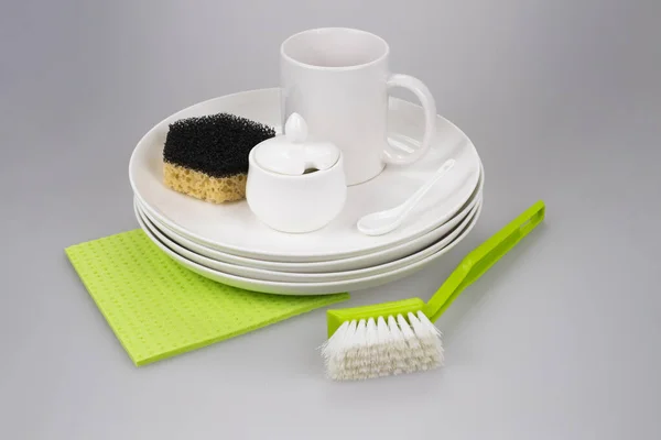 Clean dishes, sponge, cup and brush