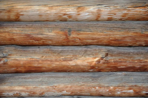 A wall of aged brown logs in the old house — Stock Photo, Image