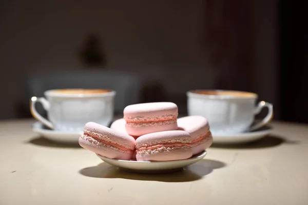 Macaroons and two cups of coffee on a vintage table — Stock Photo, Image