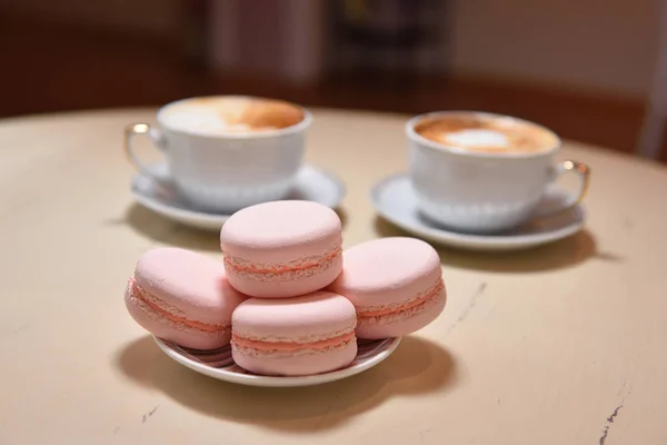 Macaroons and two cups of coffee on a vintage table — Stock Photo, Image