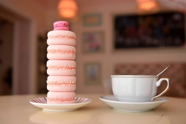 A tower made of macaroons and a cup of coffee on a beautiful vintage table — Stock Photo, Image