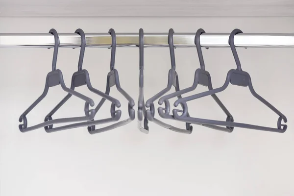 An empty wardrobe and clothes hangers in it. Hangers for clothes in an empty cupboard — Stock Photo, Image