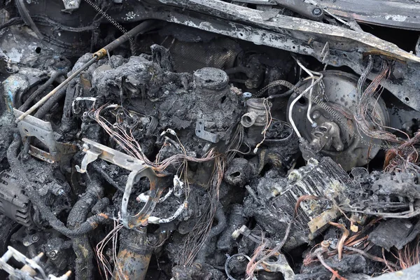 The car\'s engine after the fire. Burned out car engine, side view.