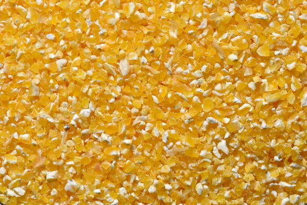 Yellow corn grits close-up. Raw corn grits for breakfast porridge
