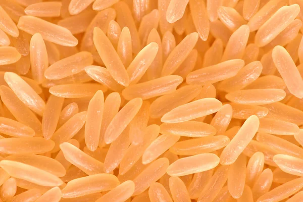 Een mooie en volumineuze lange rijst, rauw, niet gekookt. Oppervlakte rijst cerea. Gele rijst close-up Rechtenvrije Stockafbeeldingen