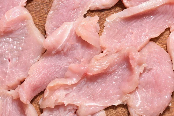 Raw and sliced turkey meat. Fresh pink turkey meat, close-up