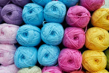 Mağazadaki rafta farklı renkler örmek için iplikler. Kapat.