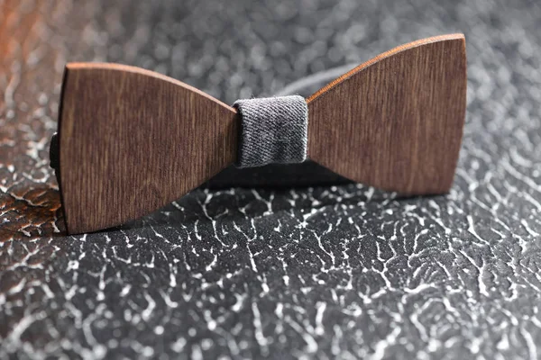 Elegante pajarita masculina de madera marrón con tela gris sobre una superficie rugosa de hierro. Accesorio para hombres brutales —  Fotos de Stock