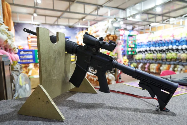 black rifle for shooting games on targets in the shooting range in an amusement park.