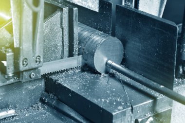 Fabrikada metali elektrikli testereyle kesme işlemi. Elektrikli testere metali kesiyor, yakın plan..