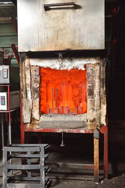 Industrial electric furnace for hardening metal parts. Hardening furnace with open door