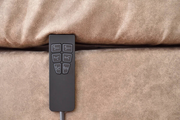 Remote control to adjust the tilt of the mattress bed, close-up