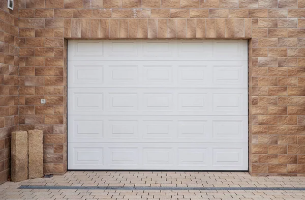 White automatic garage door on decorative brick wall