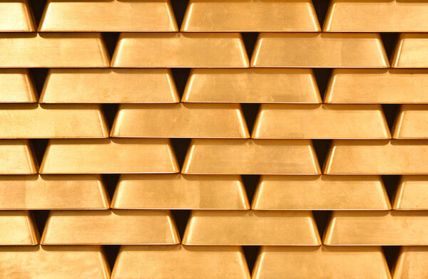 Gold bullions wall texture. Bright gold bullions. Background, pattern