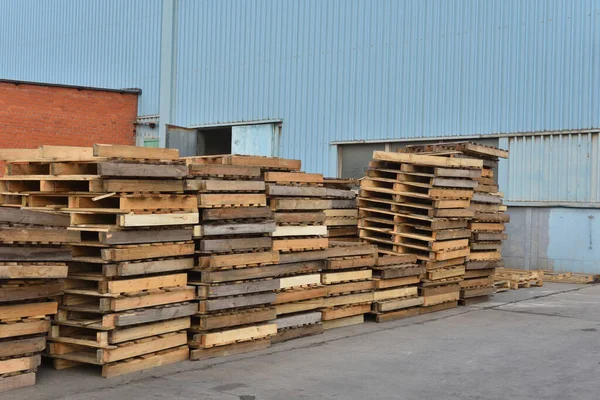 Wooden pallets in the open air at the factory. Many wooden pallets