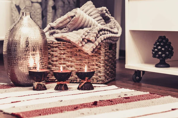 Cozy home interior decor, burning candles on a multi-colored rug — Stock Photo, Image