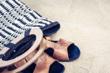 Eski yaz hasır hasır hasır bir kumsal çantası ve deri sandaletler