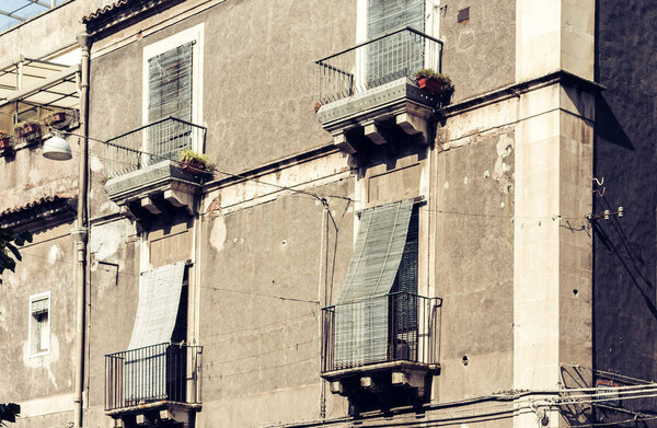 Balcony of old baroque building in Catania, traditional architecture of Sicily, Italy