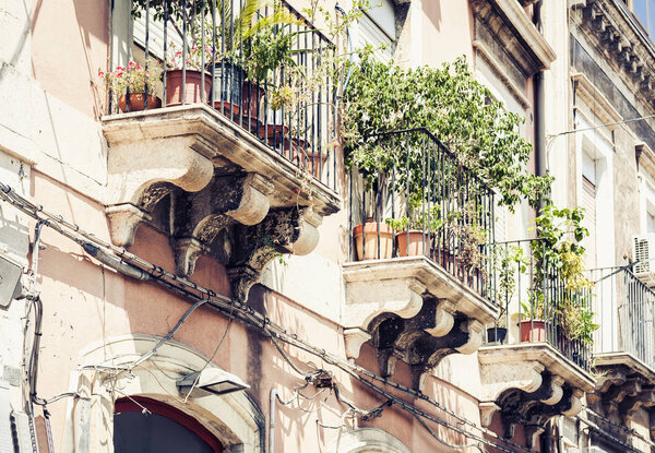 Beautiful cityscape of Italy, facade of ancient house in sicilian baroque style on historical street of Catania, Sicily