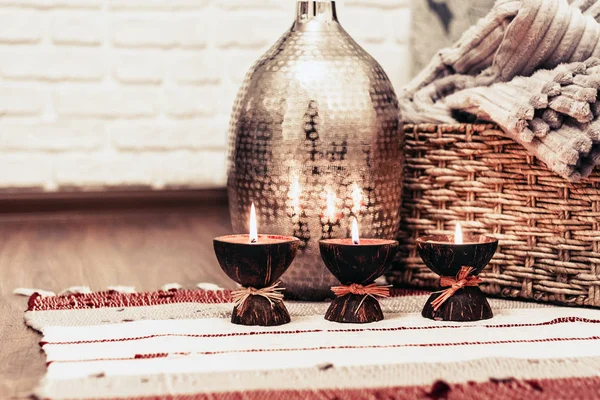 Cozy home interior decor, burning candles on a multi-colored rug — Stock Photo, Image