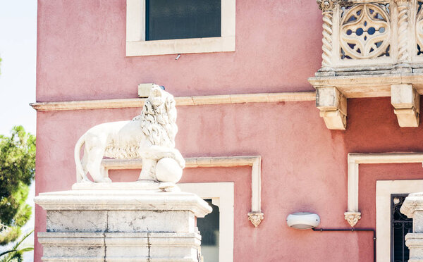 Statue of lion, balcony of an ancient building in Taormina, Sicily, Italy