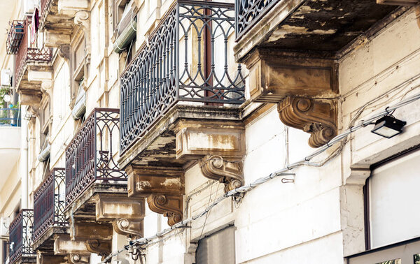 Balcony in old baroque building in Catania, traditional architecture of Sicily, Italy