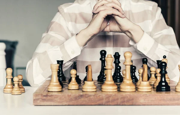 Wooden chess pieces on a chessboard, chess game woman player mak