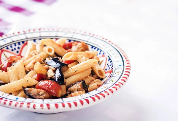 Pasta with eggplant, fish and tomato sauce in restaurant in Cata