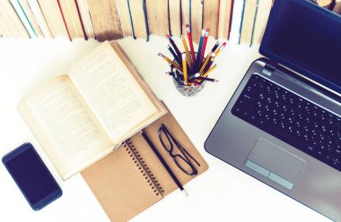 Ders kitabını aç, defter, akıllı telefon, dizüstü bilgisayar, bir yığın b