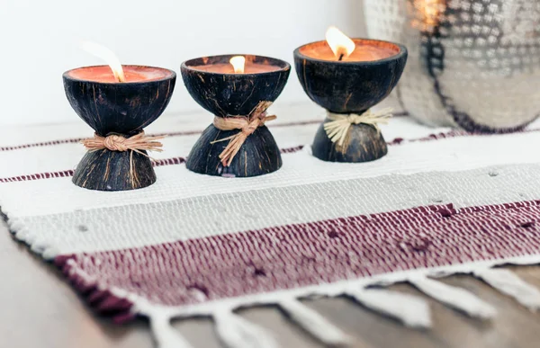 Cozy home interior decor background, burning candles in coconut — Stock Photo, Image