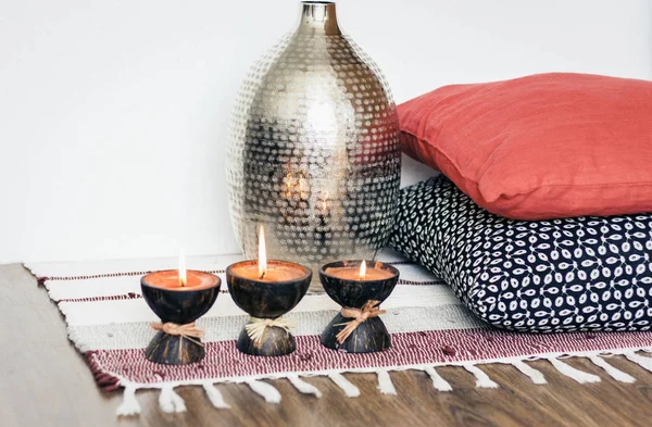 Cozy home interior decor, burning candles in coconut shell on a