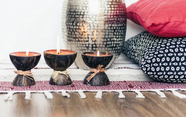 Cozy home interior decor, burning candles in coconut shell on a