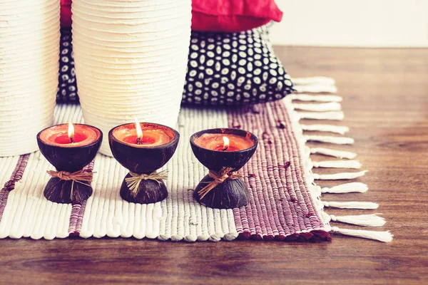 Cozy home interior decor, burning candles in coconut shell on a