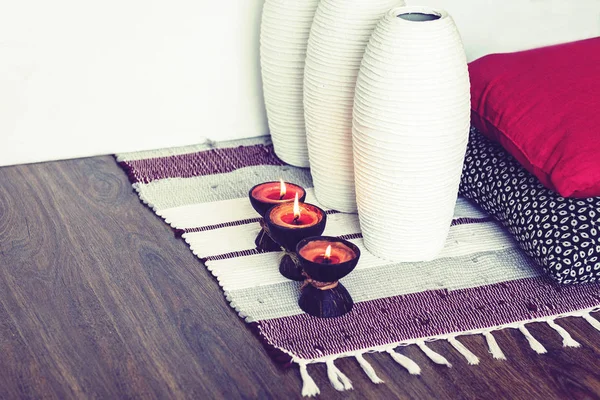 Cozy home interior decor, burning candles in coconut shell on a