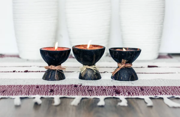 Cozy home interior decor background, burning candles in coconut — Stock Photo, Image