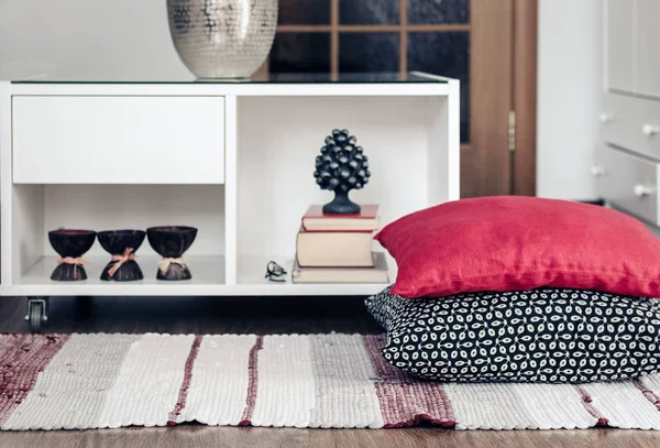 Cozy home interior decor, white nightstand with pile of books, c