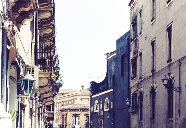 Traditional architecture of Sicily in Italy, typical street of Catania, facade of old buildings