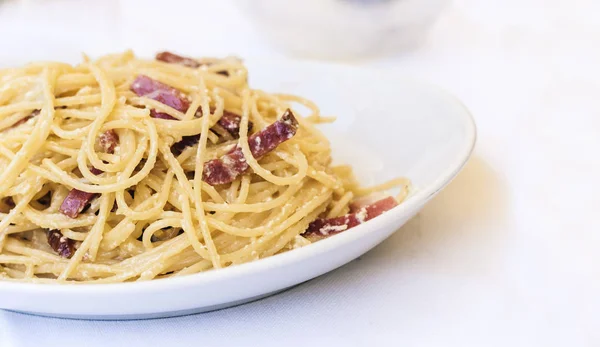 Pasta carbonara spaghetti with ham, bacon and fresh parmesan on