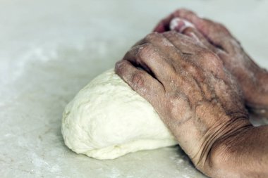 Kadınların elleri hamur işi yapmak için yoğurur. .