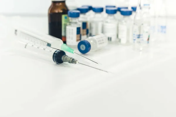 Medicine bottles, ampules and syringes on white background with — Stock Photo, Image