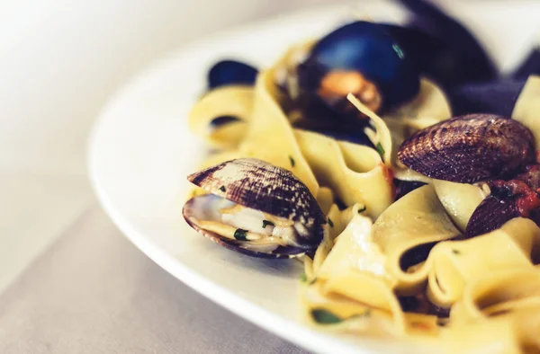 Seafood pasta spaghetti linguine wish mussels, clams, cherry tom