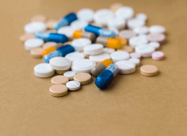 Heap of colorful pills, pharmaceutical medicine tablets and caps