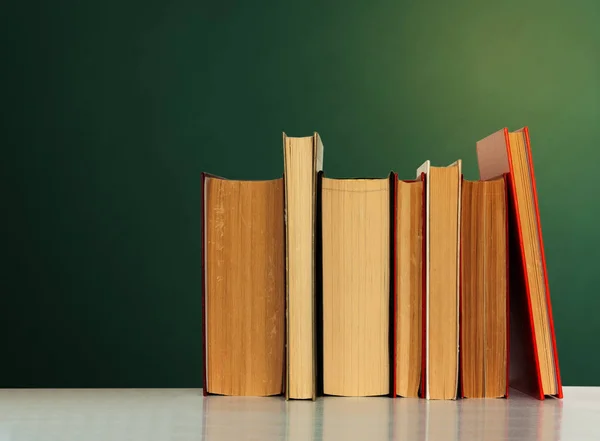 Back to school, pile of books with empty green school board back — Stock Photo, Image